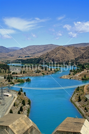 Looking from the road access across the top of the largest man made dam in the southern hemisphere.  Benmore power station and the beginning of Lake Aviemore. New Zealand