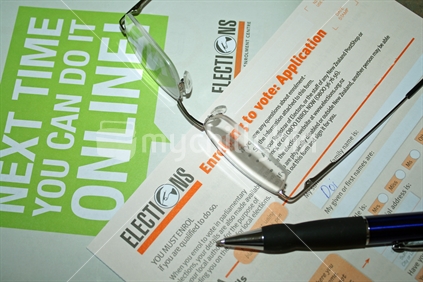 Election enrolment forms with spectacles and pen.