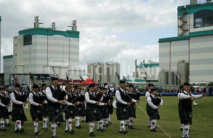 Fonterra Factory (focus), with Invercargill Highland Pipe Band in foreground.