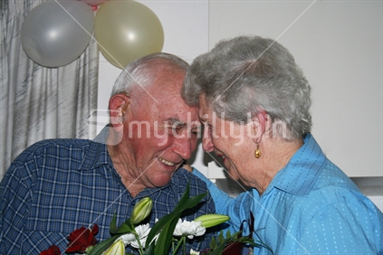 An elderly New Zealand couple proudly celebrating their 60th wedding anniversary.