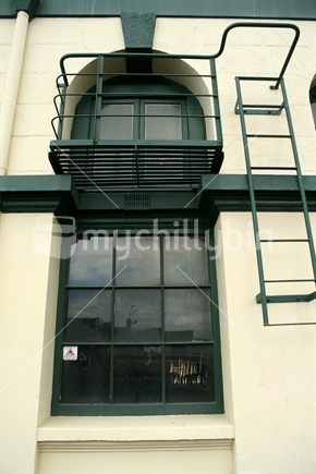 Fire escape and balcony on the exterior wall of an historic building. 