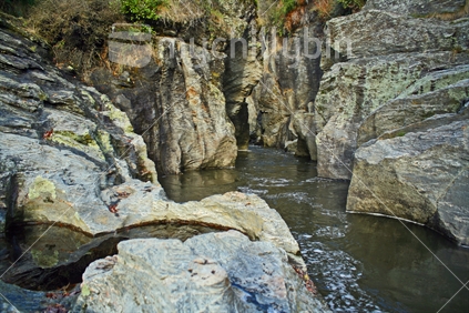 Sheer rock faces of a deep ravine in the Motatapu River, Central Otago.
