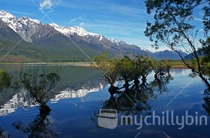 Early morning snow capped mountains reflected on Lake Whakatipu, Glenorchy, Central Otago.