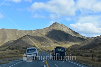 A 4WD vehicle passing safely on an open road, Lindis Pass.