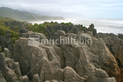Exposed layers of rocks, at Punakaiki, on an overcast day after a storm