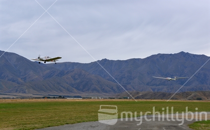 Plane and glider taking off at Omarama in McKenzie Country South Island.