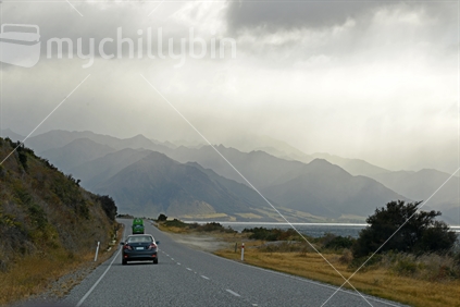 Driving the main highway along Lake Wanaka, toward Glenorchy, with mist laden hills in the distance.