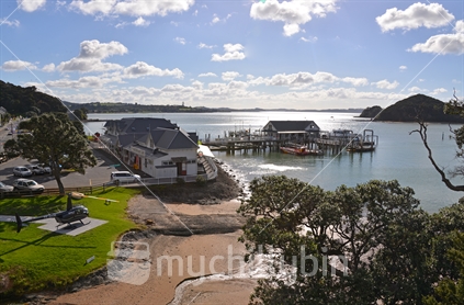 Paihia wharf and Waterfront buildings with helicopter situated in the foreground.