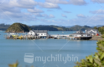 A popular tourist destination, Paihia wharf and waterfront spotlighted in sunshine.