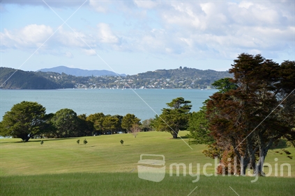 Scenic Waitangi golf course with the township of Russell across the water  in the distance.