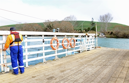 Captain readying the Tuapeka Mouth Ferry, for crossing to collect vehicles and ferry across to the other side of The Clutha River.