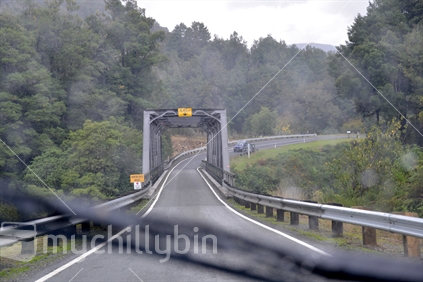Necessary to use windscreen wipers to give a clear view of traffic approaching a one way bridge, on a rainy day.
