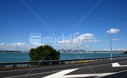 Sky tower, and Auckland CBD at a distance, as seen from Auckland South bound motorway (some motion blur)