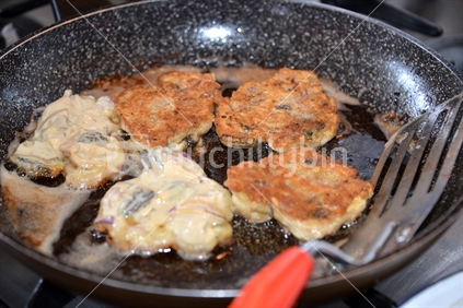 Cooking delicious crispy mussel fritters.