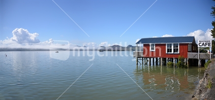 Iconic and popular café the Boat Shed extends out over a full tide on the Hokianga Harbour.