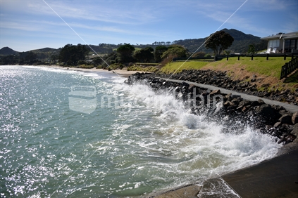 A stone wall barrier helps prevent the waves eroding the bank on the foreshore of Hokianga Harbour at Omapere.