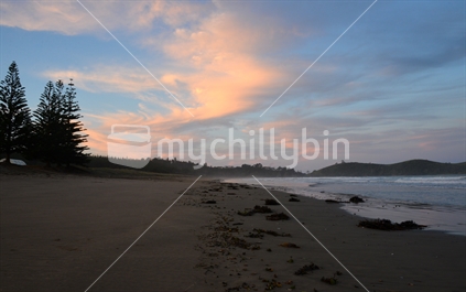 Coloured cloud at sunset, Whananaki ocean beach, Northland.