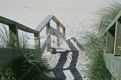Wooden steps and hand rails, leading to the beach.
