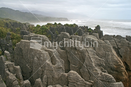 Punakaiki rocks with a view of the ocean in the distance.  West Coast, South Island