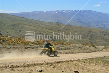 An exhilirating ride  on a quad bike along a New zealand high country dusty dirt track.