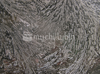 Frozen ice crystals on glass.