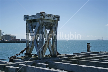 A large wooden stand with bollard on top, at the end of Bluff wharf, for ships to dock at.