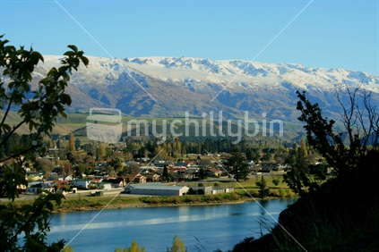 A beautiful clear spring morning, looking across Lake Dunstan to part of Cromwell residential area, Central Otago, South Island, New Zealand
