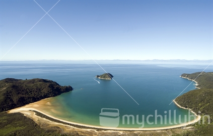 Aerial view of Abel Tasman National Park area showing a bay with blue water and golden sand, South Island, New Zealand.