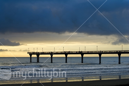 Sunset on the New Brighton pier with reflection on beach, Christchurch, South Island, New Zealand.