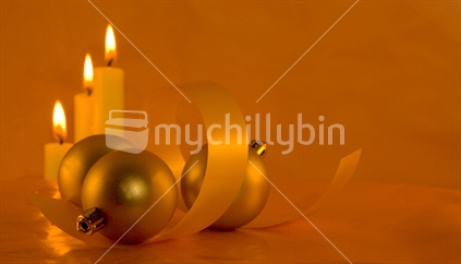 Image of three candles and festive ball decorations with ribbon, Landscape orientation, orange color