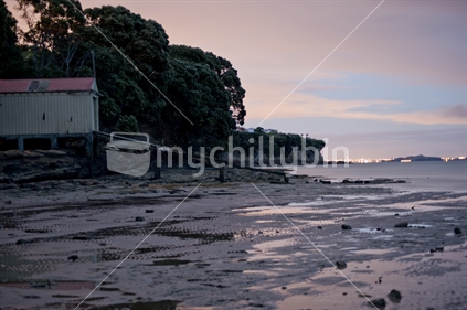 Lights of Auckland city at dawn (Sunrise) from Shelly bay beach, Beachlands, Auckand, New Zealand