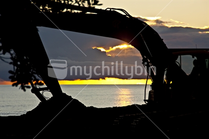 A digger working on the carpark at muriwai beach, North Island, New Zealand