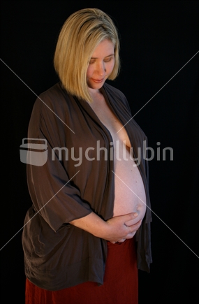 A mother holds her pregnant tummy