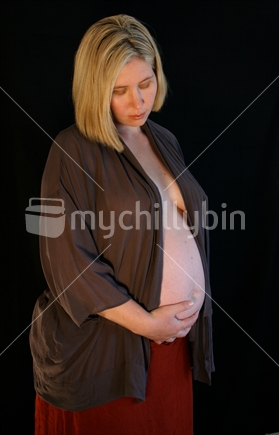 A mother holds her pregnant tummy