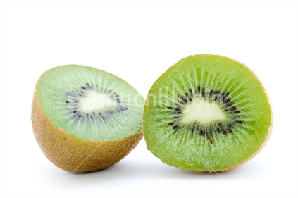 A juicy kiwifruit cut in half with a white background