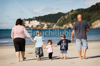 Family of five walking on beach