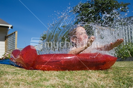 Boy on water slide