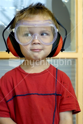 Boy wearing safety gear, goggles and earmuffs