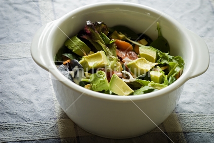 A green salad in a white bowl