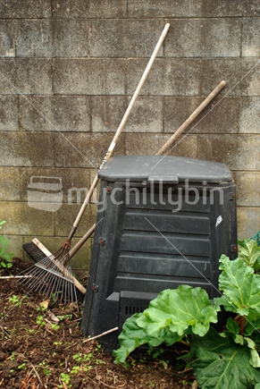 A compost bin and garden tools