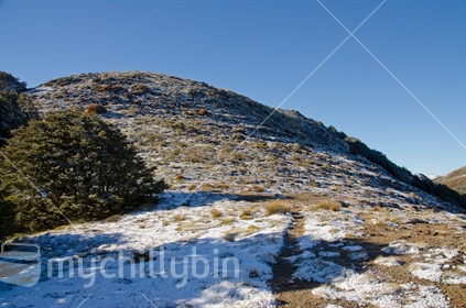 A tramping track up a steep frosty mountain