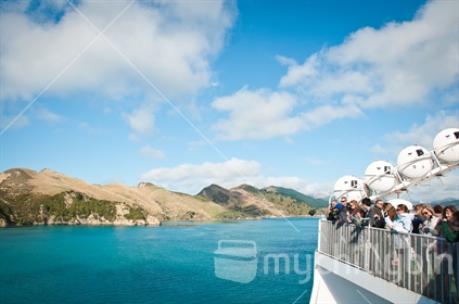 Passengers aboard a ferry take photos of the beautiful Marlborough Sounds