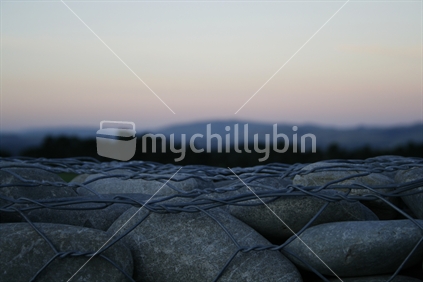 Dusky horizon behind a rock wall