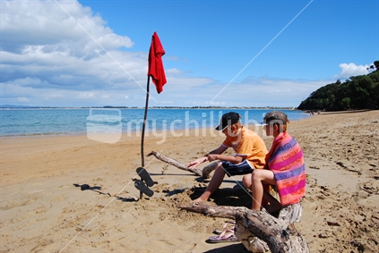 Two boys at the beach, Doubtless Bay, New Zealand