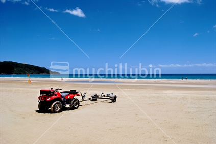 Gone Fishing; duad bike with boat trailer on beach, Shipwreck Bay, Northland, New Zealand