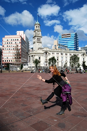 Young woman having fun in Aotea Square, Auckland, New Zealand