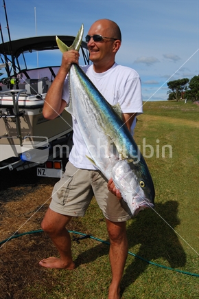 Kingfish, held by a proud fisherman, Doubtless Bay, Far North