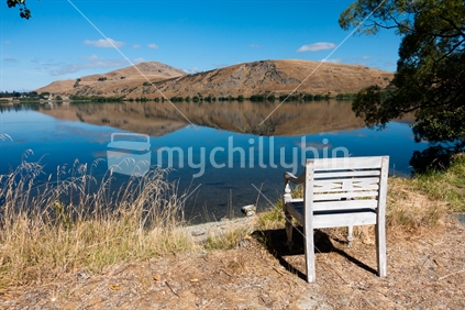 Chair looking out onto Lake Hayes reflections -near Queenstown 