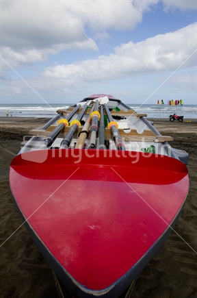 Red surfboat at Piha on the West Coast
