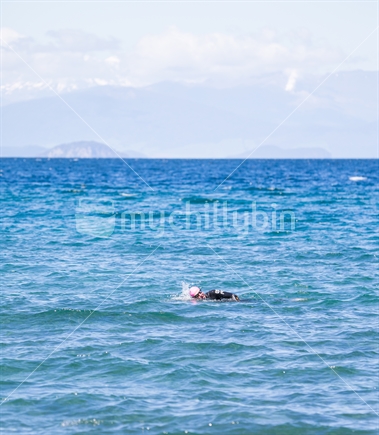 A keen swimmer in lake Taupo, 